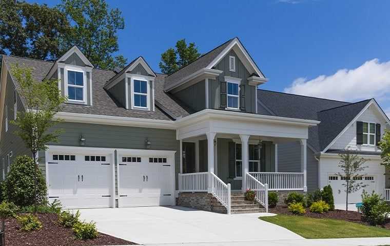 a gray two story house with an attached garage